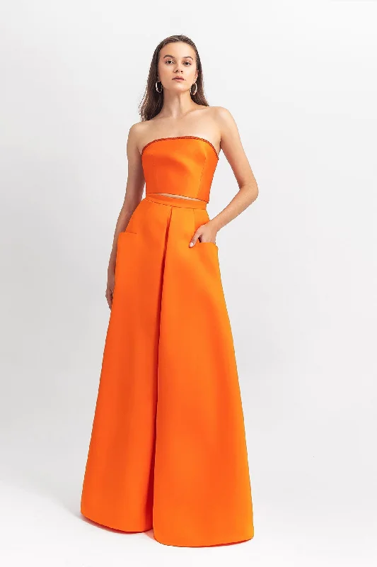 Strapless satin long dress with sequins details on the back; with front pockets on the skirt